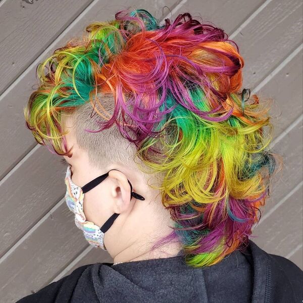 Colorful Rainbow Mohawk Curls- a woman wearing a face mask and a black jacket