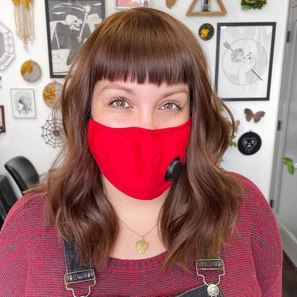 Cool Brown Hair- a woman with hazel eyes wearing a red face mask