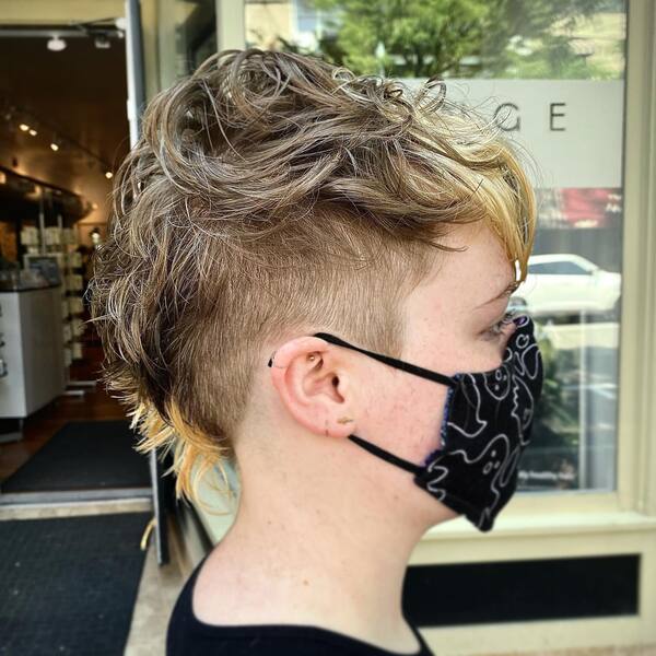 Curly Faux Hawk- a woman wearing a black face mask