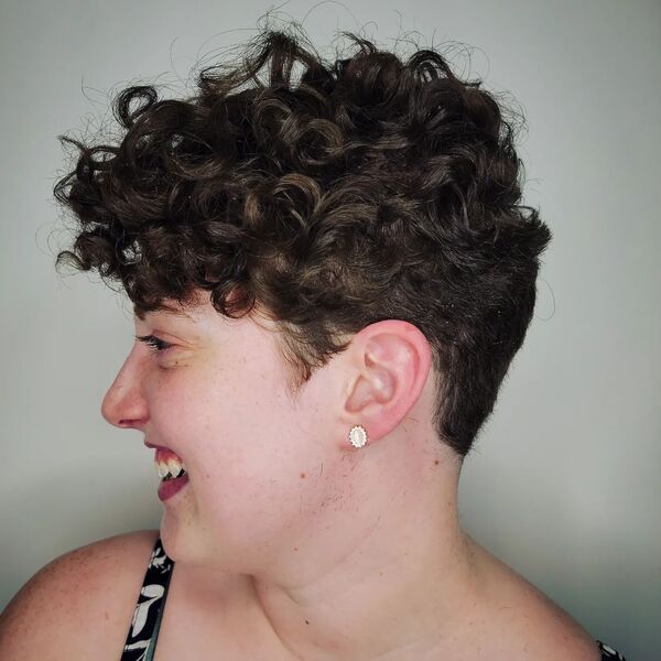Curly Pixie Cut for Thick Hair- a woman wearing a black camisole