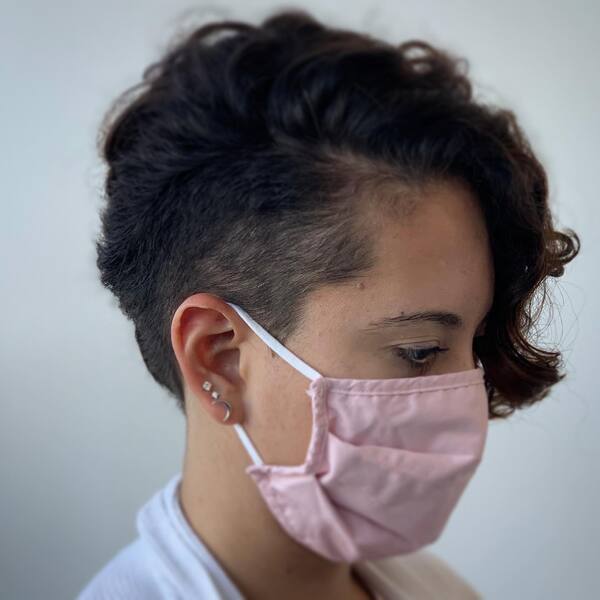 Curly Shaved Hairstyles for Women- a woman wearing a pink face mask