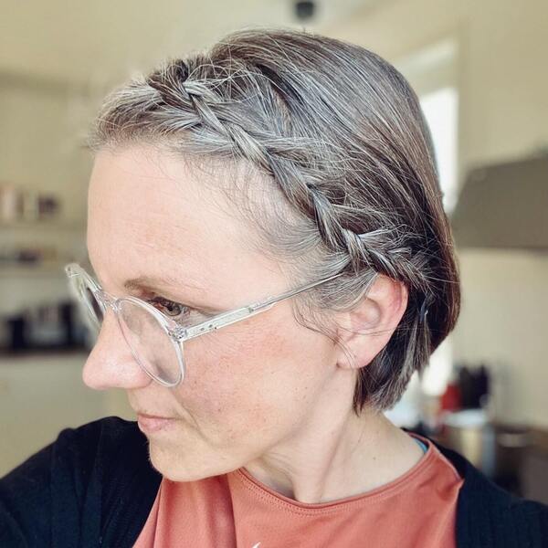 Cute Little Braid- a woman with gray hair wearing a reading glasses