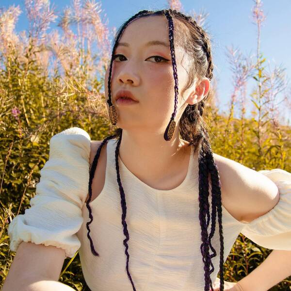 Cute Thin Braids- an Asian woman wearing a white dress
