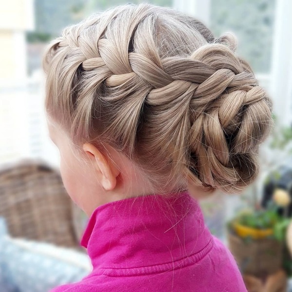 Double French Braided Updo- a girl wearing a pink polo shirt