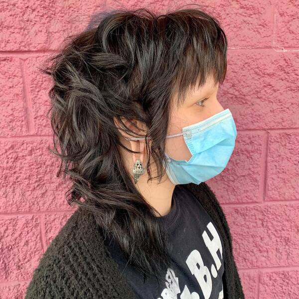 Edgy Mullet with Sharp Angles- a woman wearing light blue face mask