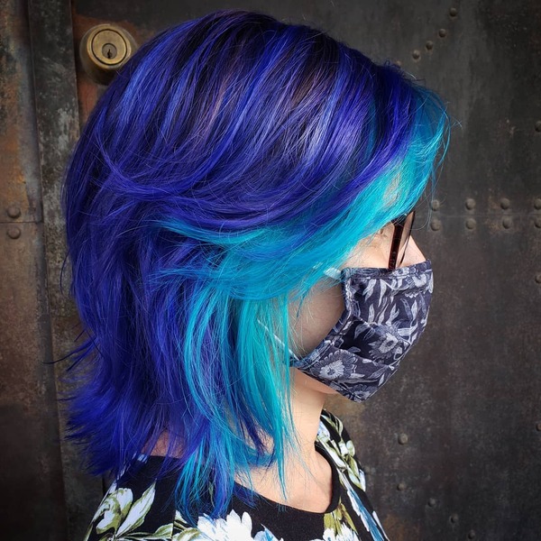 Electric Blue Hair Color- a woman wearing a face mask