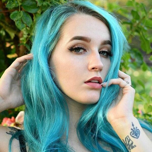 Electric Turquoise Hair Color- a woman wearing a floral camisole