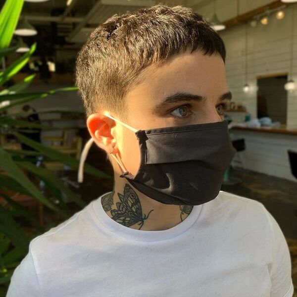 Fade Haircuts for Women- a woman wearing a black face mask and a white t-shirt