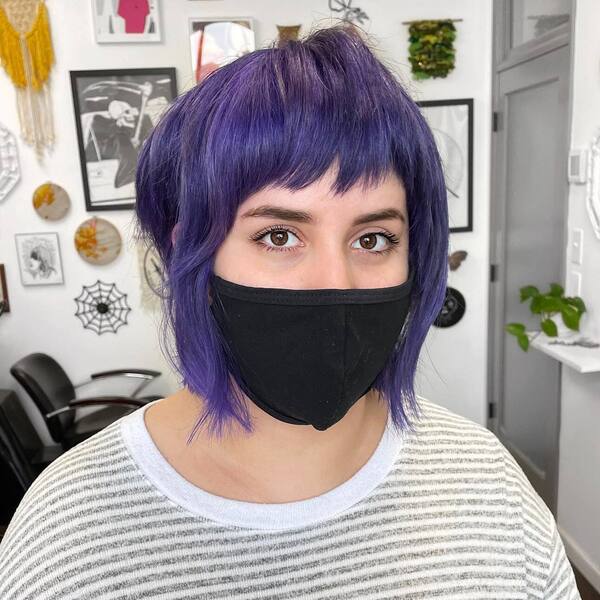Faded Purple Hair- a woman with hazel eyes wearing a black face mask