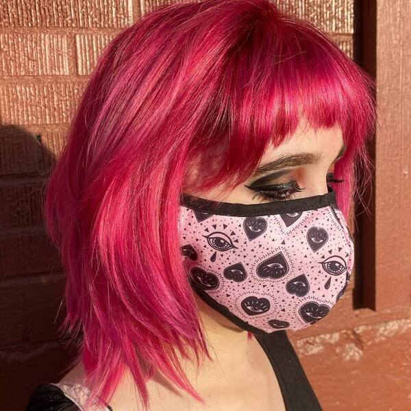 Feathered Fuchsia Hair Color- a woman wearing a face mask