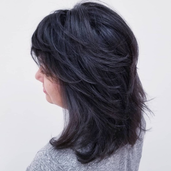 Feathered Layered Shoulder-length Haircut for Brunettes- a woman wearing a gray shirt