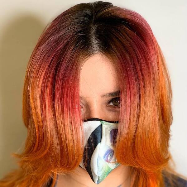 From Dark to Bright Orange Gradient- a woman wearing a face mask
