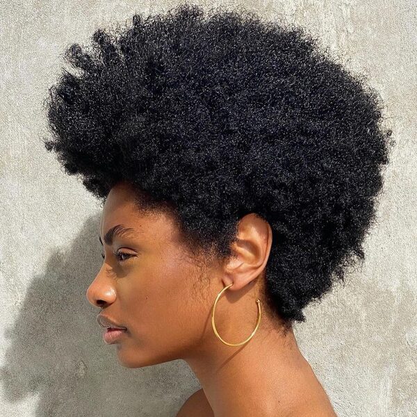 Full Afro for Black Women- a black woman wearing a big earrings