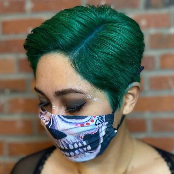 Green With Envy- a woman wearing a face mask