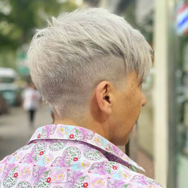 Growing Out Gray Hair with Fades- a woman with gray hair wearing a floral polo