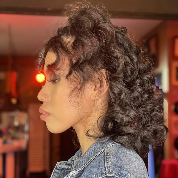 Half Up 80's Hairstyles- a woman wearing a denim jacket