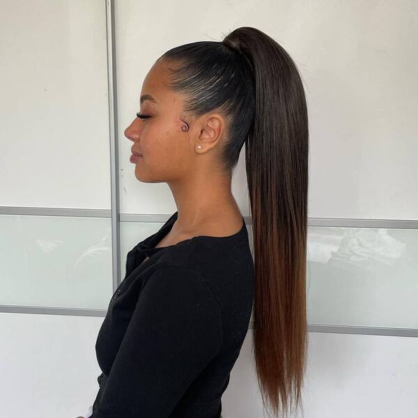 High Ponytail Hairstyle for Brunettes- a woman wearing a black blouse