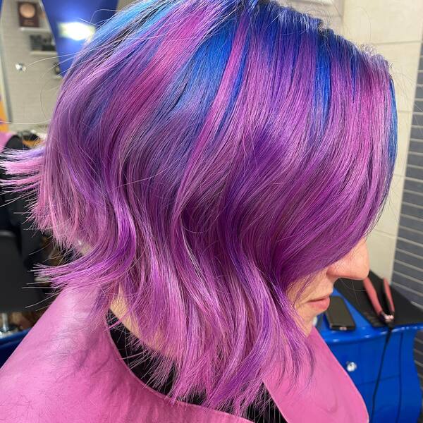 Layered Hairstyles with Blue and Pink Hair Colors- a woman wearing a pink barber's cape