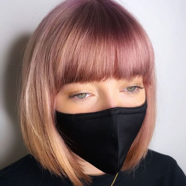 Lightly Highlighted Short Bob Haircuts- a woman wearing a black face mask