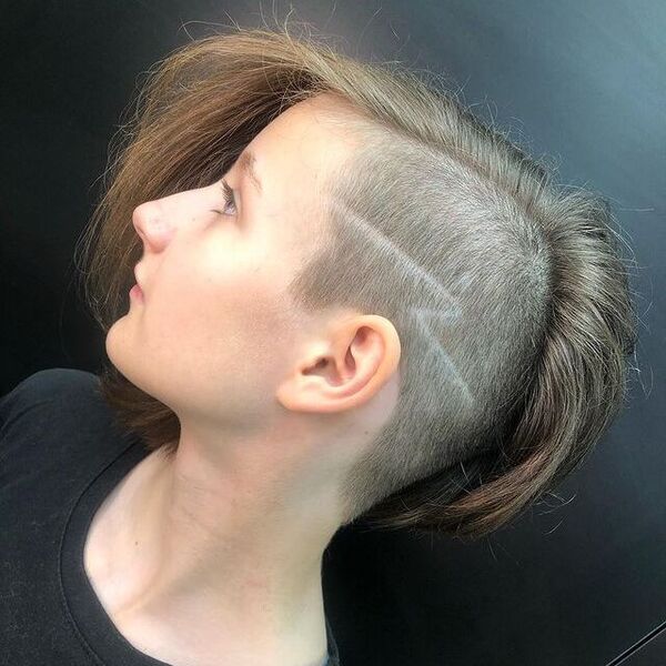 Lightning Bolt Razor Cut Design with a Side Shaved Haircut- a woman wearing a black t-shirt