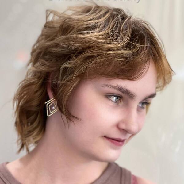 Messy 80's Inspired Hairstyles- a woman wearing an earrings
