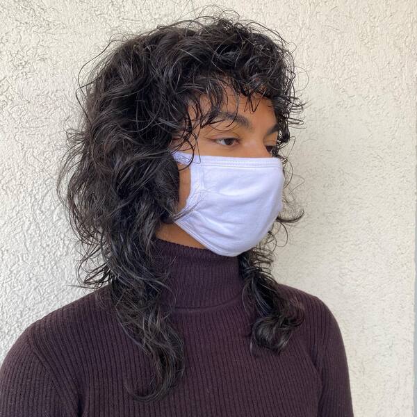 Messy Curls- a woman wearing a white face mask and a turtle neck sweater