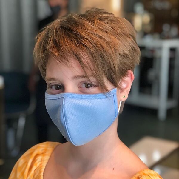 Messy Long Pixie Haircut- a woman wearing a blue face mask