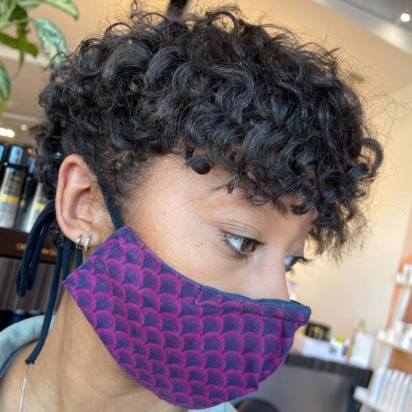 Messy Pixie Curls- a woman wearing a purple face mask