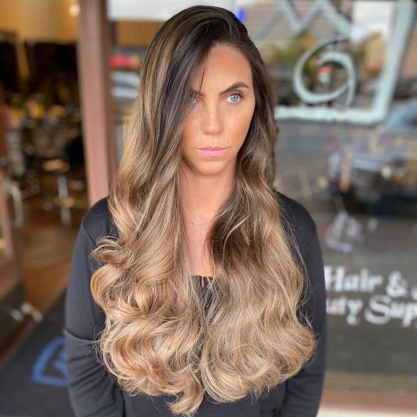Milk Chocolate to Dirty Blonde Ombre for Brunettes- a woman wearing a black sweater blouse