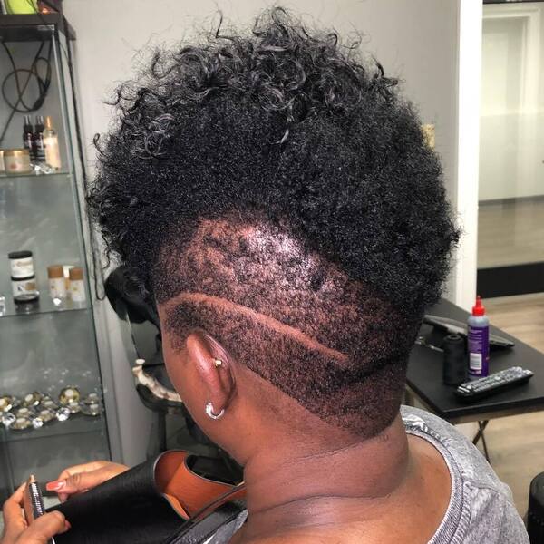 Mohawk Haircuts for Black Women- a black woman wearing a gray shirt