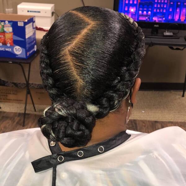 Nice and Neat Braids- a woman wearing a white barber's cape