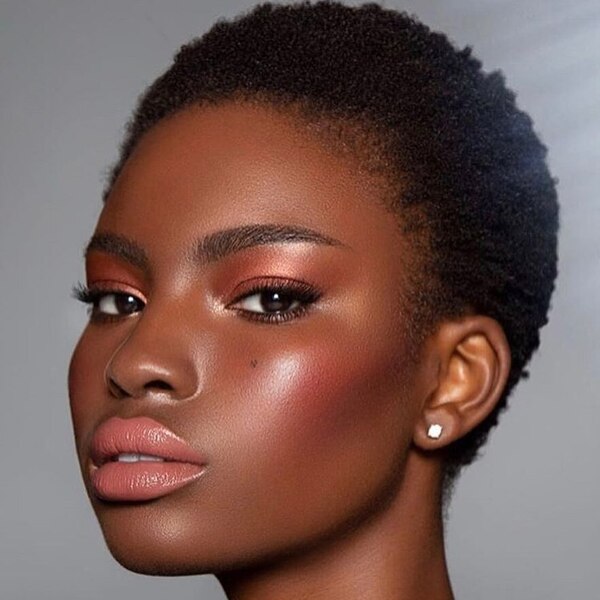 Overgrown Buzz- a black woman wearing a make-up