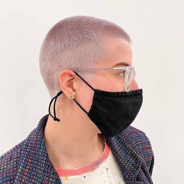 Overgrown Shaved Hairstyles for Women- a woman wearing a black face mask