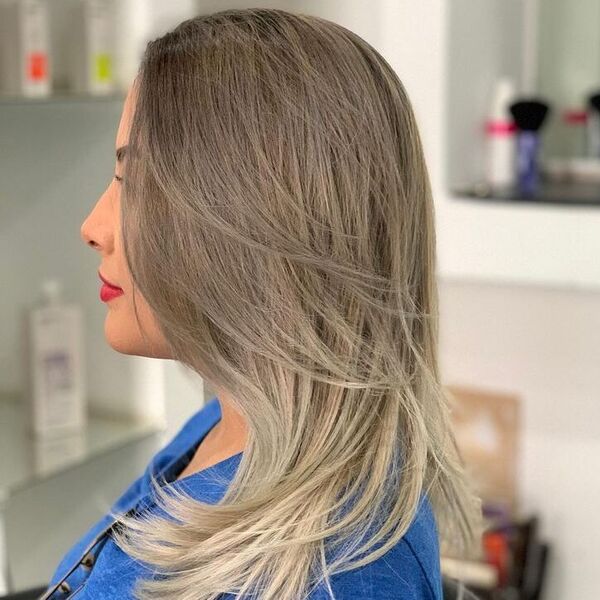 Pale Brown to Silvery Blonde Ombre Hairstyle- a woman wearing a blue t-shirt
