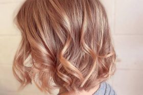 Peachy Pastel Pink for Wavy Short Hair- a woman wearing a gray sweater dress