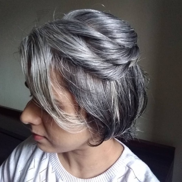 Petrol Waves- a woman with gray hair wearing a white sweater