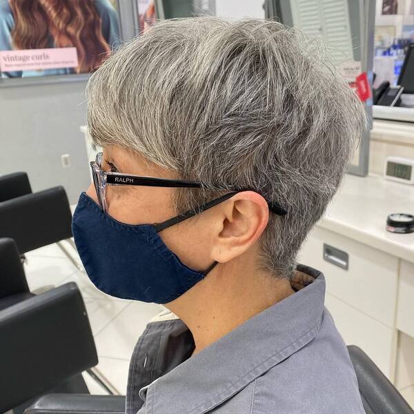 Pixie Cut Hairstyles for Growing out Gray Hair- a woman with gray hair wearing a royal blue face mask