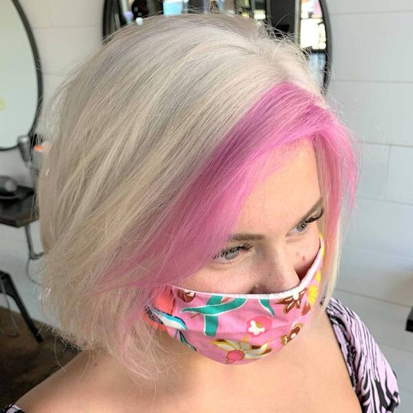Platinum White- a woman wearing a pink face mask