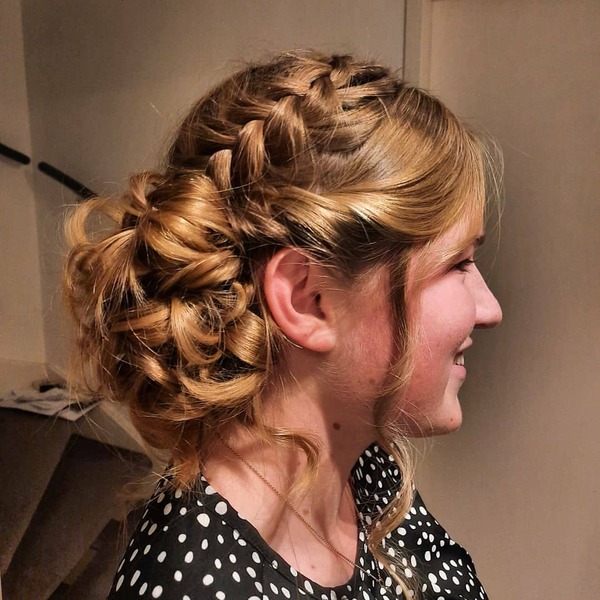 Prom French Braid Styles- a woman wearing a black blouse