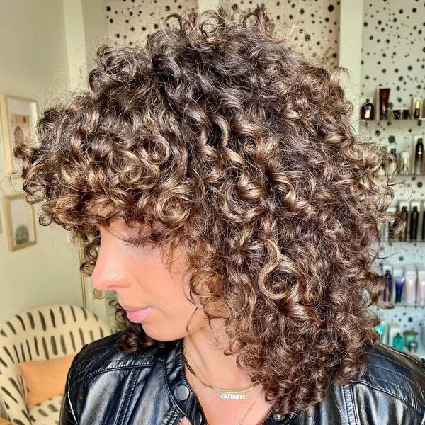 Protective Curls Fall Hair Colors- a woman wearing a black leather jacket