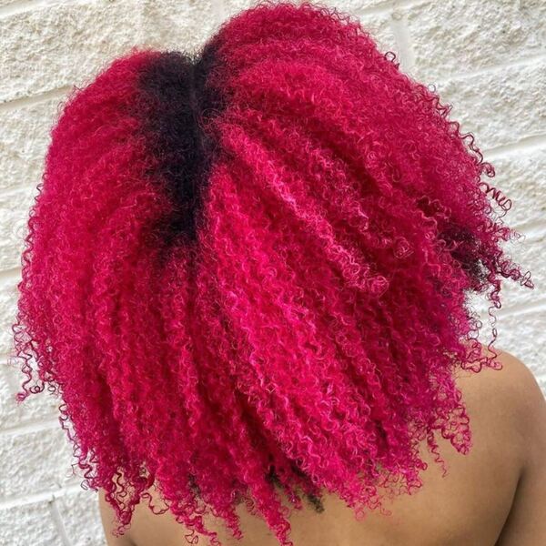 Protective Pink Curly Hairstyles- a woman wearing a camisole