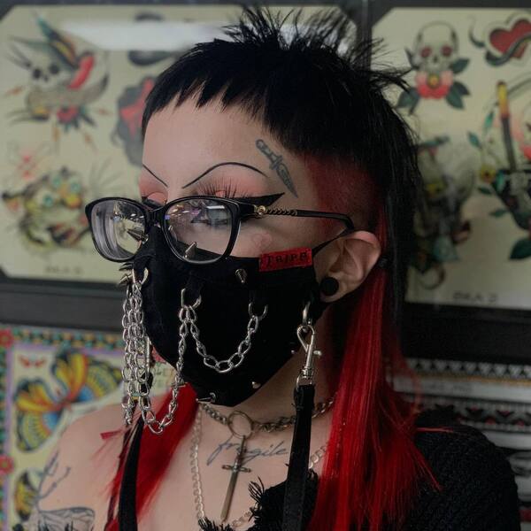 Punk Fade Shag Haircut- a woman wearing a black face mask