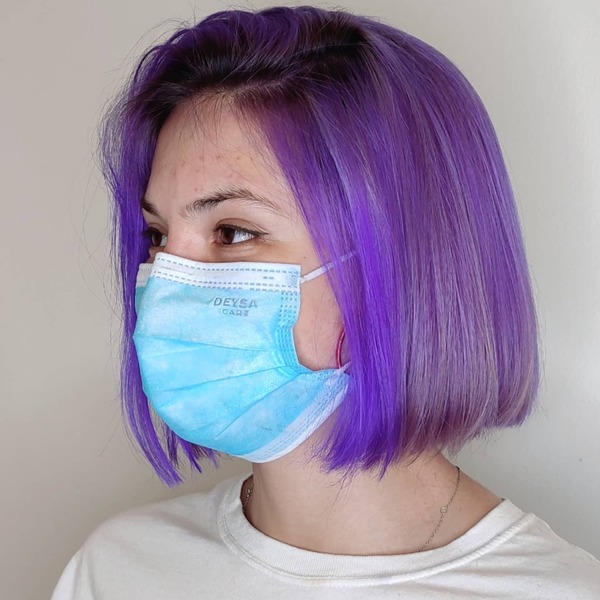 Purple Short Bob Haircuts- a woman wearing a face mask and a white t-shirt