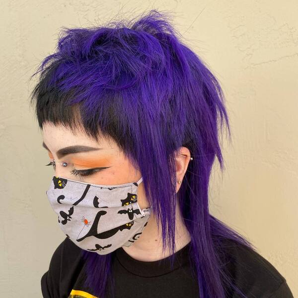 Purple Terror- an Asian woman wearing a face mask and a black face mask