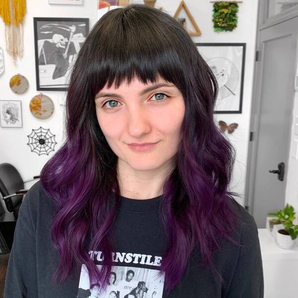Purple Tips- a woman with hazel eyes wearing a black t-shirt