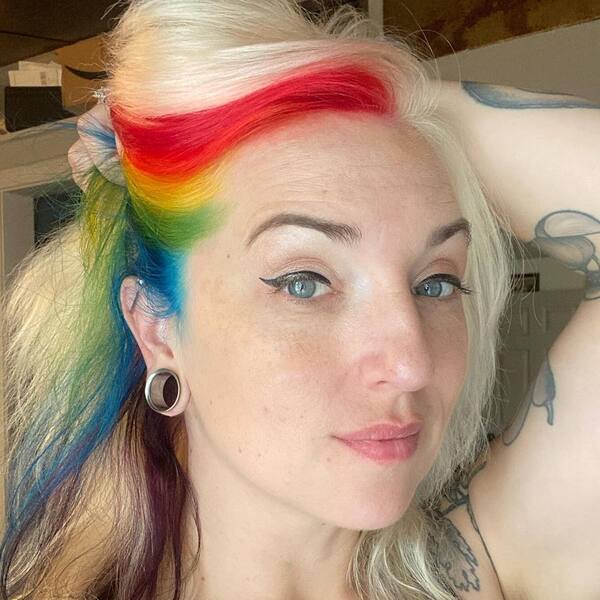Rainbow Hair- a woman wearing a big silver earrings