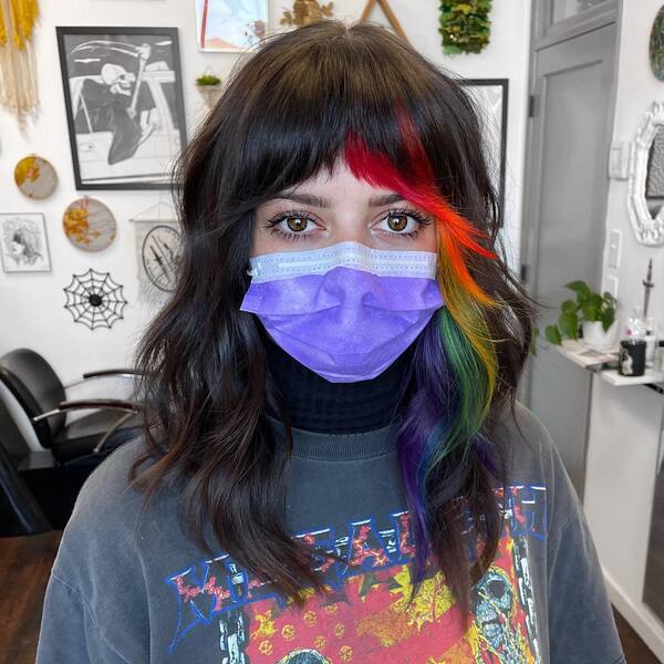 Rainbow Streak Hairstyle- a woman wearing a purple face mask