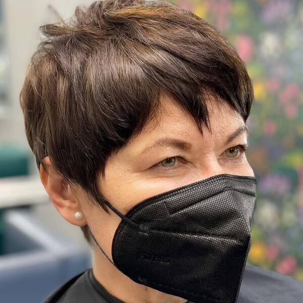 Razor Cut Pixie- a woman over 60 wearing a black face mask