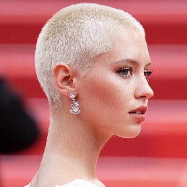 Red Carpet Hairstyle- a woman wearing a white dress