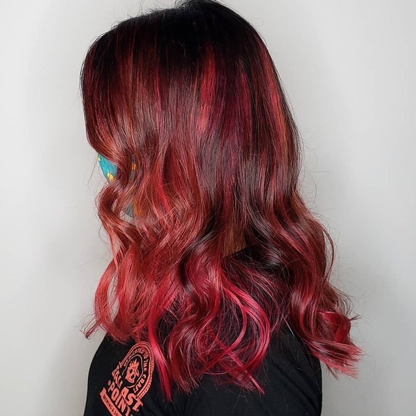 Red Highlights for Fall Hair Color Ideas- a woman wearing a black t-shirt
